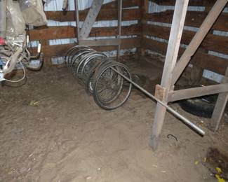 Lot 51. Bicycle wheels and items on the rack above