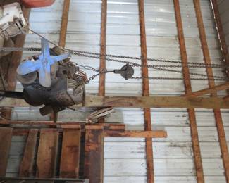 Lot 59. Chevy motor and chain hoist. GM 8737739 with FI209D stamped on the front of the motor.