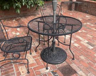 $140 Wrought Iron bistro dining table 36" diameter x 29"h. with two chairs.  Umbrellas and stands not for sale.