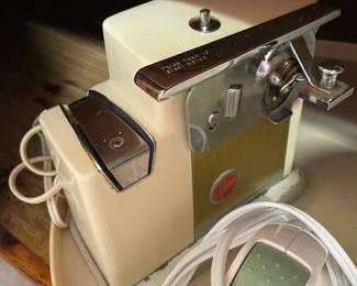 This is a Hoover can opener/knife sharpener.  Which is confusing on so many levels.  Who thought to combine those two things randomly?  Something that uses a blade to open metal and also something that uses metal to sharpen blades.  Also who knew Hoover made anything other than vacuums.