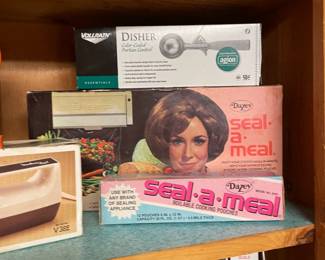 Seriously - look at that seal a meal box!  All of our appliance boxes are like white with a picture the appliance, and the name in big black font.  Look at those colors, look at her hair!  Do I think for one second that lady has ever sealed a meal in her life?  No.  Would I have bought it based on that box?  Absolutely.