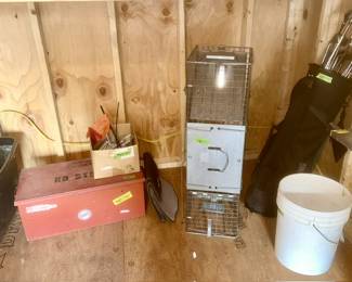 Red metal hinged top box, live trap, golf clubs, etc.