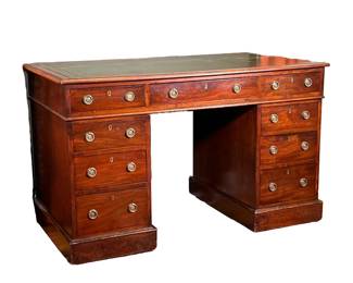 ENGLISH MAHOGANY PEDESTAL WRITING DESK | Oblong top with gilt-tooled green leather writing surface and molded edge projecting over 3 drawers and 2 tiers of flanking 3 drawers . - l. 48 x w. 26.25 x h. 30 in