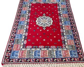 MOROCCAN CARPET | Central medallion on a red field with wide geometric border, worked in shades of red, blue, white, gray, and beige. - l. 98 x w. 66 in
