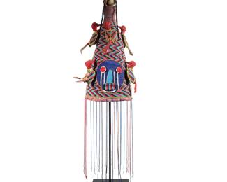 YORUBA BEADWORK HEADDRESS | Colorful Yoruba beadwork headdress showing colorful birds down a zig-zag pattern to 2 faces on opposite sides with long strands of beads hanging from the rim on black metal stand. -  h. 40.5 x dia. 9 in