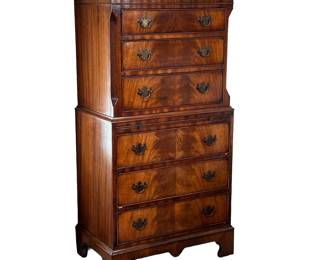 GEORGE III STYLE FLAME MAHOGANY CHEST ON CHEST | Diminutive chest on chest, having six drawers with a medial molding, canted corners, brushing slide, flame, mahogany veneer drawer fronts with brass pulls - one piece construction. - l. 18 x w. 28 x h. 54 in