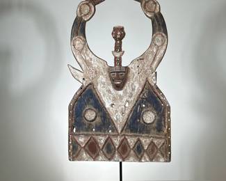 AFRICAN WOOD CARVING | Hand carved and painted African wood carving on black metal stand. - l. 22.5 x w. 10 x h. 46 in