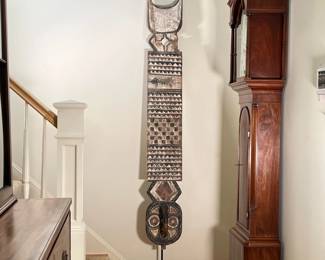 LARGE AFRICAN WOOD CARVING | Large African wood carving on metal stand showing various patterns, carved crocodile relief leading to face-like carving in bottom with horn. - l. 12 x w. 12 x h. 97 in