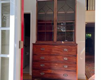 GEORGIAN MAHOGANY SECRETARY BOOKCASE | Circa 1770, flame mahogany with line inlay. Double glazed cabinet doors over a fitted secretary drawer with 6 pigeon holes over 3 full width drawers raised on bracket feet. 2 piece construction. 