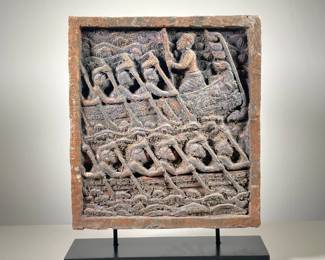 INDONESIAN TERRA COTTA RELIEF PANEL | Showing rowers on a boat rowing through wavy seas, carved terra cotta relief on black stand. - l. 14.75 x w. 4.5 x h. 18.75 in