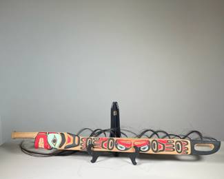 NATIVE PACIFIC NORTHWEST WOOD CARVING | Wood carving from Pacific Northwest showing carved and painted figures on wooden sword with tassels of hair leading to carved face at the bottom just above the handle. -  l. 3 x w. 1.5 x h. 36 in
