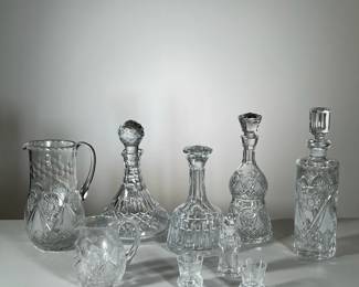 (9PC) CUT CRYSTAL | Including for decanters to pitchers a small bottle with a stopper and two cordial glasses. - h. 13 in (tallest)