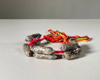 BURMESE PRESSED METAL NECKLACE | Pressed metal beads with colorful tassles