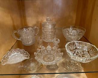 This is a china closet full of assorted vintage clear glass! 