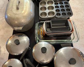 A complete banquet table full of vintage and usable cookware! At the bottom of the picture is an entire set of Vintage Revere Ware with Lids and Copper Bottoms Stainless USA! 