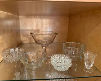 This is a china closet full of assorted vintage clear glass! 