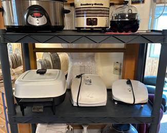 An entire rack of small kitchen appliances! All in excellent working condition! Many with their original manuals. Crock Pots, George Foreman Grills, Popcorn Poppers, Food Processors, Mixers etc...