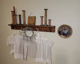 Antique baby dresses and wooden spools