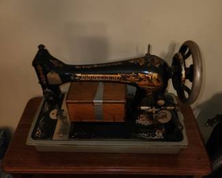 Antique Singer Sewing machine with the extra special box at front desk with the shuttle