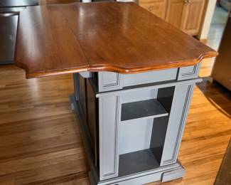 Kitchen Island which has a to that folds down or up 