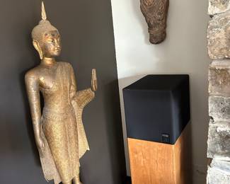 Thai bronze Buddha standing figure, Bangkok School (mid 19th c ) measures 50" on wood mount. . Wooden ox head from Kerala, India on wall above pair of Reference Series KEF stereo speakers on pedestals, 4'  high. Model 107 reference series
