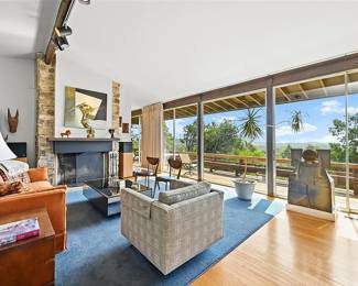 Clean vintage modernist furnishings, rugs, lighting, and decor. "Cracked Chest" 3' x 2'  Ceramic sculpture by Victor Babu(1936 - 2019) , original  40 x 40 1967 Richard Stout artwork over mantle "Intersection" or "Encounter."