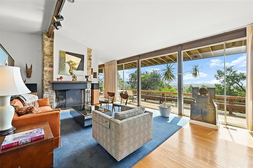 Clean vintage modernist furnishings, rugs, lighting, and decor. "Cracked Chest" 3' x 2'  Ceramic sculpture by Victor Babu(1936 - 2019) , original  40 x 40 1967 Richard Stout artwork over mantle "Intersection" or "Encounter."