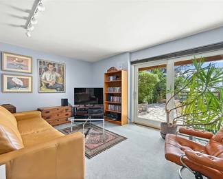 Ekornes Made in Norway Leather Lounge chair w Ottoman, Leather sofa, teak bookshelf , Qum Bijar Persian rug wool/ cotton  5' 10" x 3' 5" , modernist glass and chrome x-base coffee table (art shown on walls in not available) 