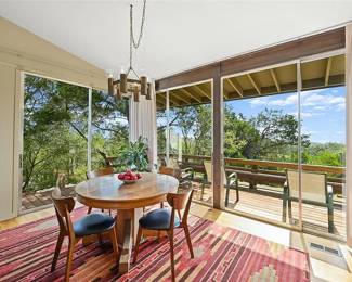 Round oak pedestal table, 6 modernist reproduction chairs bent wood with black vinyl seat covers Southwestern sunset theme room size rug