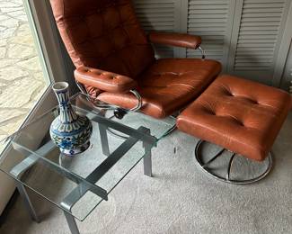 EKORNES Norwegian leather MCM swivel armchair with ottoman. Modernist metal and glass table.