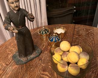 Carved wooden Mexican Santo. Trifle bowl with a dozen Italian alabaster apples.