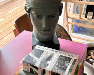 1962 AMR plaster charioteer of Delphi, 15 inches high on base on purple parsons table.