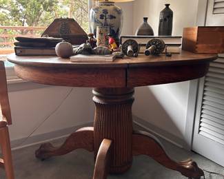 Oak round table with claw and ball feet.