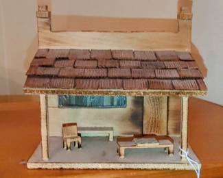 This handmade diorama/tramp art planter . front is shaped like a small town post office, the rear a functional houseplant container with 5-inch diameter base. The front porch has a couple of small chairs situated around a checkerboard, there's a tiny horseshoe hanging over the door, and the plexiglass window reads, US Post Office 1901
