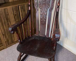 Antique rocker with carved face and inlaid head rest
