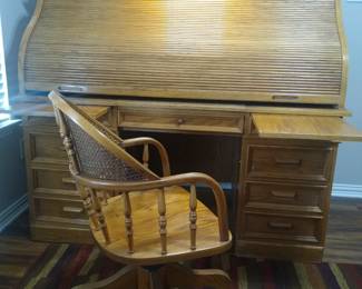 Solid oak, rolltop desk with matching wicker-back chair