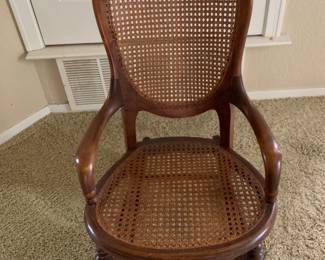 Vintage Wood and Cane Rocking Chair. H = 36. W =28.5. D 26