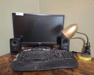 Computer Monitor, Logitech Speakers, Gold Tone Lamp and Keyboard