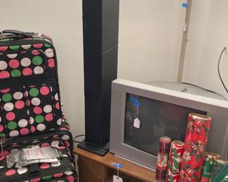 Tall Speaker; TV; TV Console; Assortment of Christmas Wrap; Torchiere style lamp; Polka Dot Luggage Set.