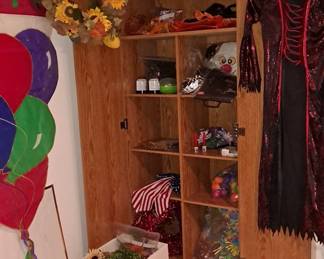 Assorted Seasonal & Holiday Decor; Fall, Halloween, Birthdays... including a Tall Wood-Looking Storage Cabinet with Shelving & Doors.