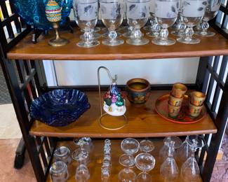 Packed shelves of lovely vintage glassware along with silver leaf frosted barware
