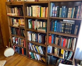 3 overloaded bookcases with a wide assortment of literature