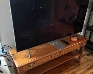 55” SONY smart TV displayed on top of oak 2 drawer sofa table.