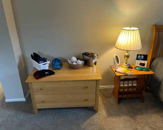 One of three piece open bedroom set, bedside table and lamp, socks and gloves.