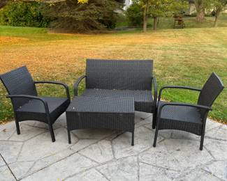 Synthetic wicker couch, two chairs and matching  table.