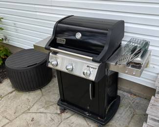 Weber grill and round storage unit.