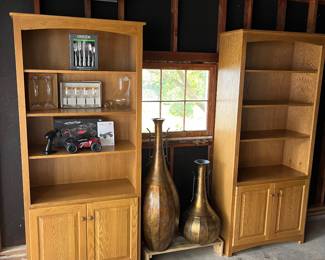 Matching bookcases and floor vases.