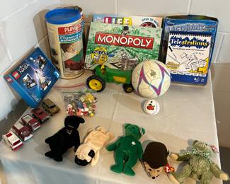 Beanie babies, boardgames, soccer ball, baseballs, Lego set, metal fire trucks and vintage toy tractor.