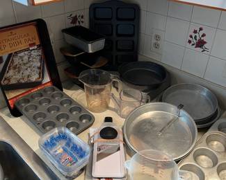 Bread pans, muffin pans, cake pans and measuring cups.