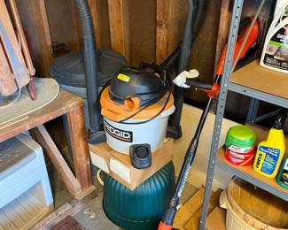 Rigid shop vac with all accessories, plastic 30 gallon trash can with lid and black n decker cordless weed whacker.